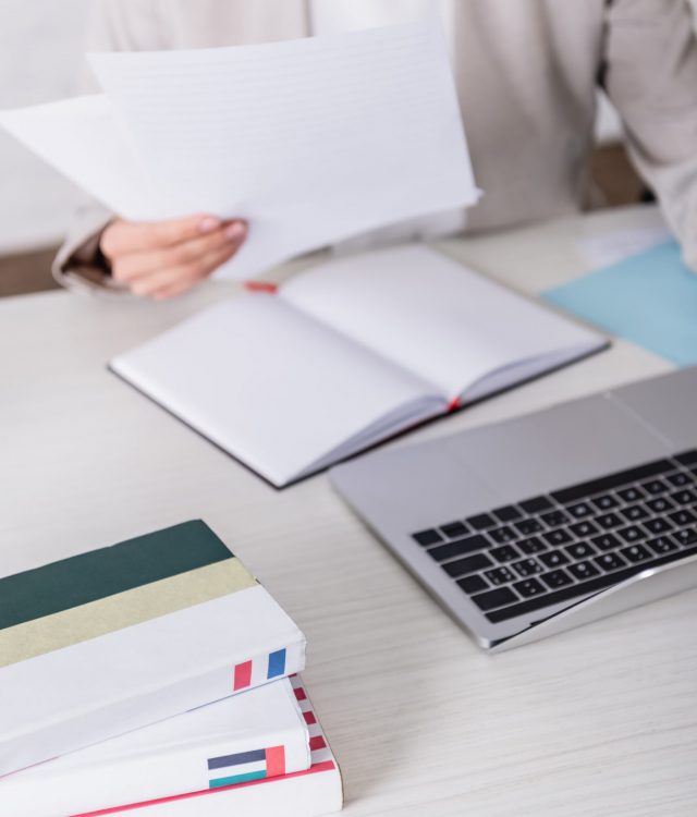 VistaCreate-437809990-stock-photo-cropped-view-translator-holding-documents